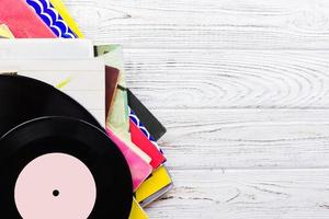 old records stack. vintage on wooden background photo