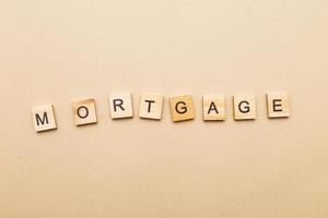 inscription mortgage on a beige background made by wooden blocks photo