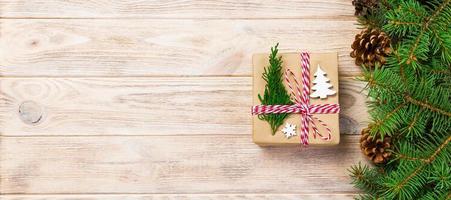 Christmas gift box wrapped in recycled paper, with ribbon bow, with ribbon on rustic background. banner Holiday concept photo