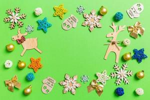 Top view of green background with New Year toys and decorations. Christmas time concept with copy space photo