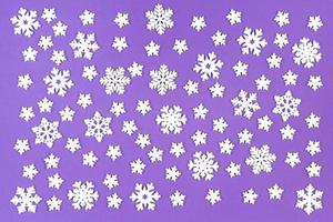 Top view of white snowflakes on colorful background. Winter weather concept with copy space. Merry Christmas concept photo