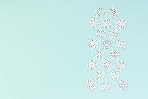 Set of white snowflakes on colorful background. Top view of Christmas ornament. New Year time concept with empty space for your design photo