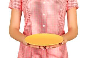 cafe worker demonstrates an empty round yellow plate in front of him. perspective view Template for your design. isolated on white background photo