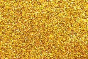 glittering background of golden sequins closeup. Sparkle festive texture photo