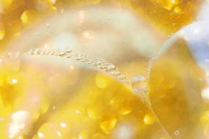 Gold Oil bubbles close up. circles of water macro. abstract shiny yellow background photo