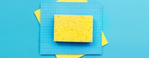kitchen rags and sponges on a blue background. flat lay. banner photo