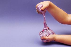 Making slime at home. child stretching colorful slime. DIY concept. photo