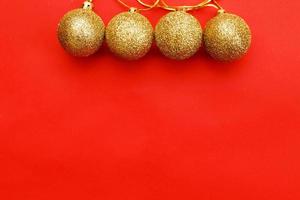 Gold Christmas balls on a red background photo