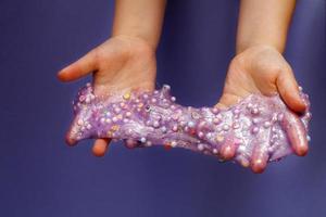 Making slime at home. child stretching colorful slime. DIY concept. photo