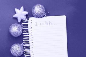 Christmas balls and toys with empty blank note sheet Very Peri color of the year photo