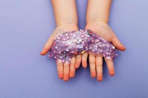 Making slime at home. child stretching colorful slime. DIY concept. Very Peri photo