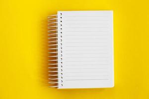 Top view of blank note paper on yellow background photo