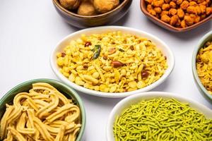 Indian Tea time snacks in group. Sev, chivda, farsan, mixture, bakarwadi served in different bowls photo