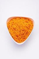 Tomato sev is a crispy crunchy orange colored flavored fried farsan with salt and spice powders photo