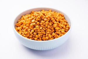 Fried and Spicy Chana Dal Masala namkeen is a popular Chakna recipe. served in a bowl photo