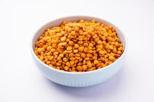 Fried and Spicy Chana Dal Masala namkeen is a popular Chakna recipe. served in a bowl photo