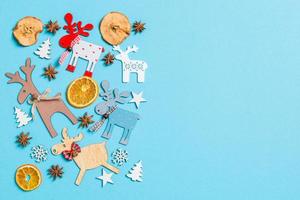 Top view of holiday decorations and toys on blue background. Christmas ornament concept with empty space for your design photo
