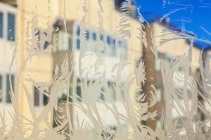 Frozen winter window with shiny ice frost pattern texture photo