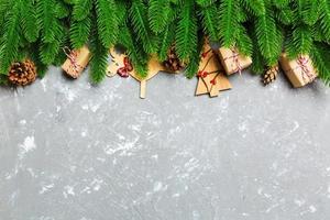 Top view of Christmas background made of fir tree and decorations on cement background. New year holiday concept with copy space photo
