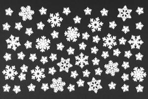 Top view of white snowflakes on colorful background. Winter weather concept with copy space. Merry Christmas concept photo