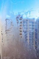 Frozen winter window with shiny ice frost pattern texture photo