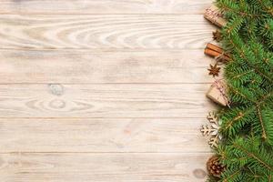 Christmas background with fir tree and gift box on wooden table. Top view with copy space for your design photo