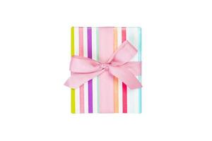 Christmas or other holiday handmade present in colored paper with pink ribbon. Isolated on white background, top view. thanksgiving Gift box concept photo
