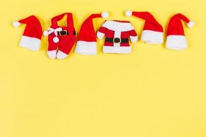 Top view red Santa hats on colorful background. Time for holiday concept with empty space for your design photo