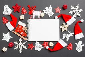 Top view of notebook. New Year decorations on black background. Merry Christmas concept photo