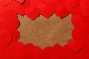 Valentine Day Background. Red paper hearts on black wooden desk with copyspace photo