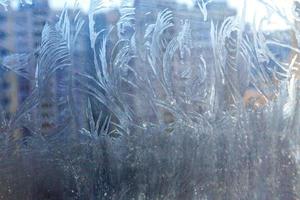 Frozen winter window with shiny ice frost pattern texture photo