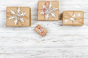 Christmas wooden background with gift boxes and decor. Top view with copy space for your text photo