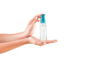 Female hand holding cream bottle of lotion isolated. Girl give tube cosmetic products on white background photo