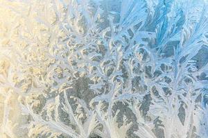 Frozen winter window with shiny ice frost pattern texture. Christmas wonder symbol, abstract background. Extreme north low temperature, natural Ice snow on frosty glass, cool winter weather outdoor. photo