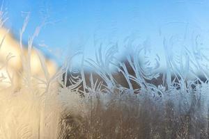 Frozen winter window with shiny ice frost pattern texture photo