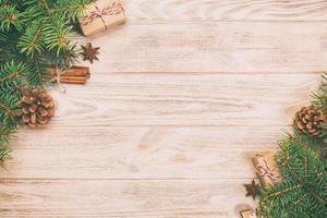 Christmas background with fir tree and gift box on wooden table. Top view vintage, toned with copy space for your design photo