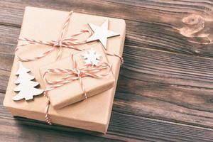 Christmas wooden decorations with snowflakes, white stars and Xmas trees on a background of black vintage old wooden boards. Background for your text and design. Toned photo