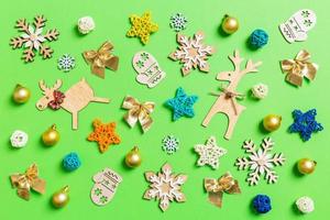 Top view of green background with New Year toys and decorations. Christmas time concept photo
