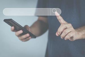 The concept of using technology to search for information, a man's hand is using a smartphone to search for information on social media via the Internet online. photo