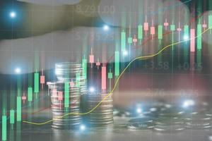 Financial stock market graph and rows of coins concept rows of coins lined up There is a graph showing growth and savings to plan for independent spending photo