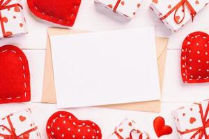 Envelope Mail with Red Heart and gift box over White Wooden Background. Valentine Day Card, Love or Wedding Greeting Concept photo