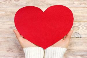 woman hand holding paper red heart shape. copy space photo