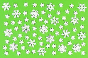 Set of white snowflakes on colorful background. Top view of Christmas ornament. New Year time concept with empty space for your design photo