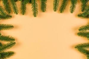 Top view of colorful festive background made of fir tree branch. Christmas holiday concept with copy space photo