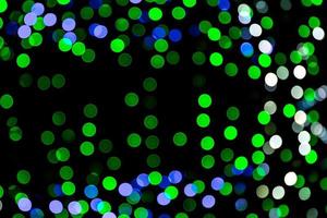 Unfocused abstract colourful bokeh on black background. defocused and blurred many round light photo