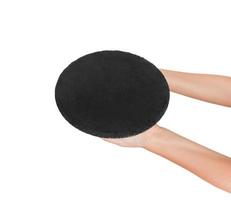 empty black slate round stone in the hand. perspective view Template for your design. isolated on white background photo