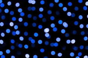 Unfocused abstract colourful bokeh black background. defocused and blurred many round blue light photo