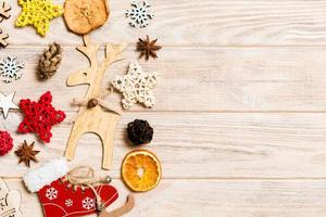 Top view of Christmas decorations and toys on wooden background. Copy space. Empty place for your design. New Year concept