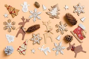 Top view of New Year toys and decorations on orange background. Christmas time concept photo