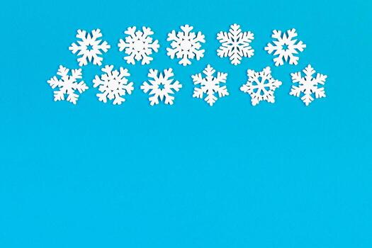 Set of white snowflakes on colorful background. Top view of Christmas ornament. New Year time concept with empty space for your design photo